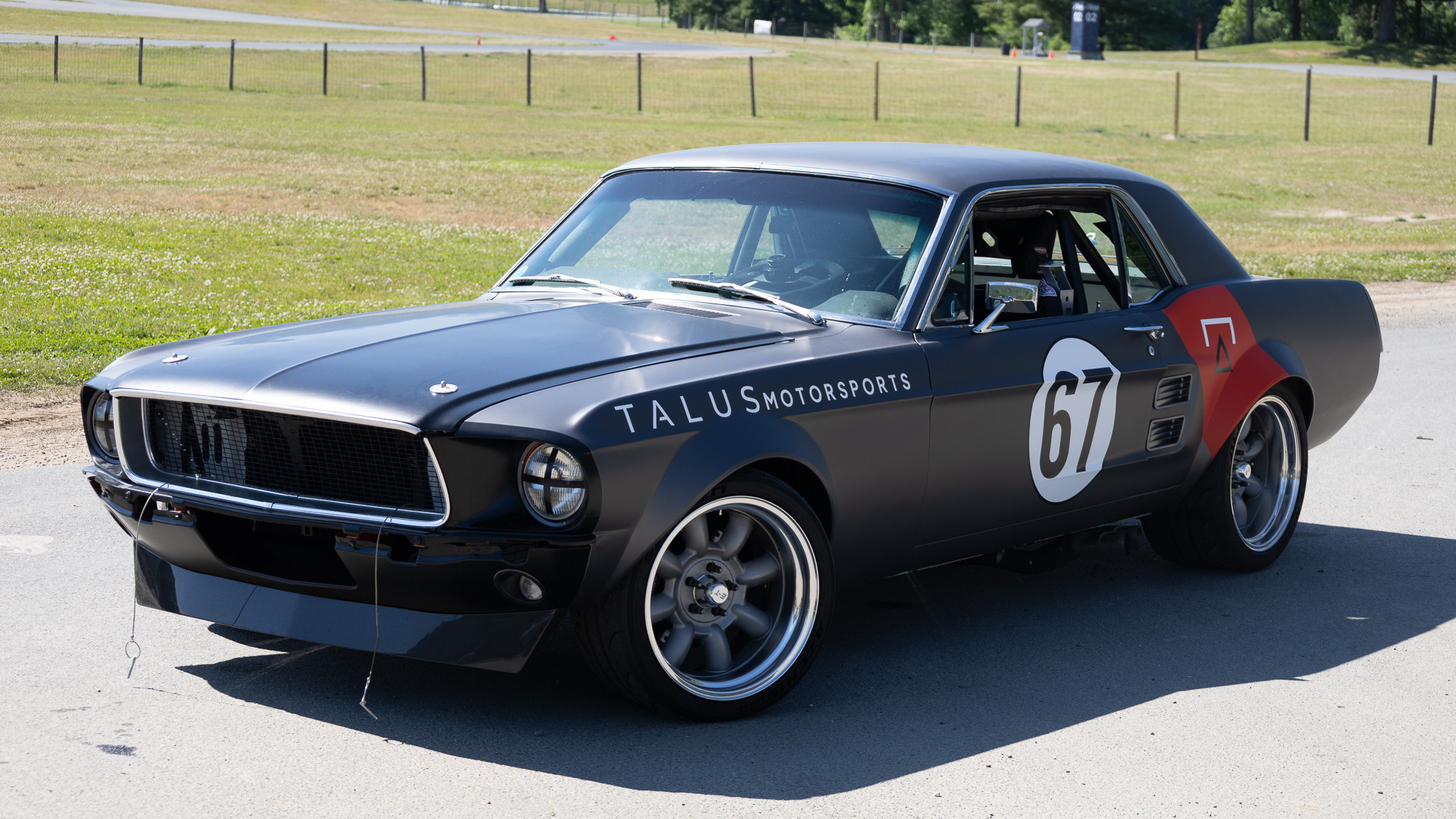 High-angle front three-quarter view of the 1967 Mustang Coupe at Lime Rock Park