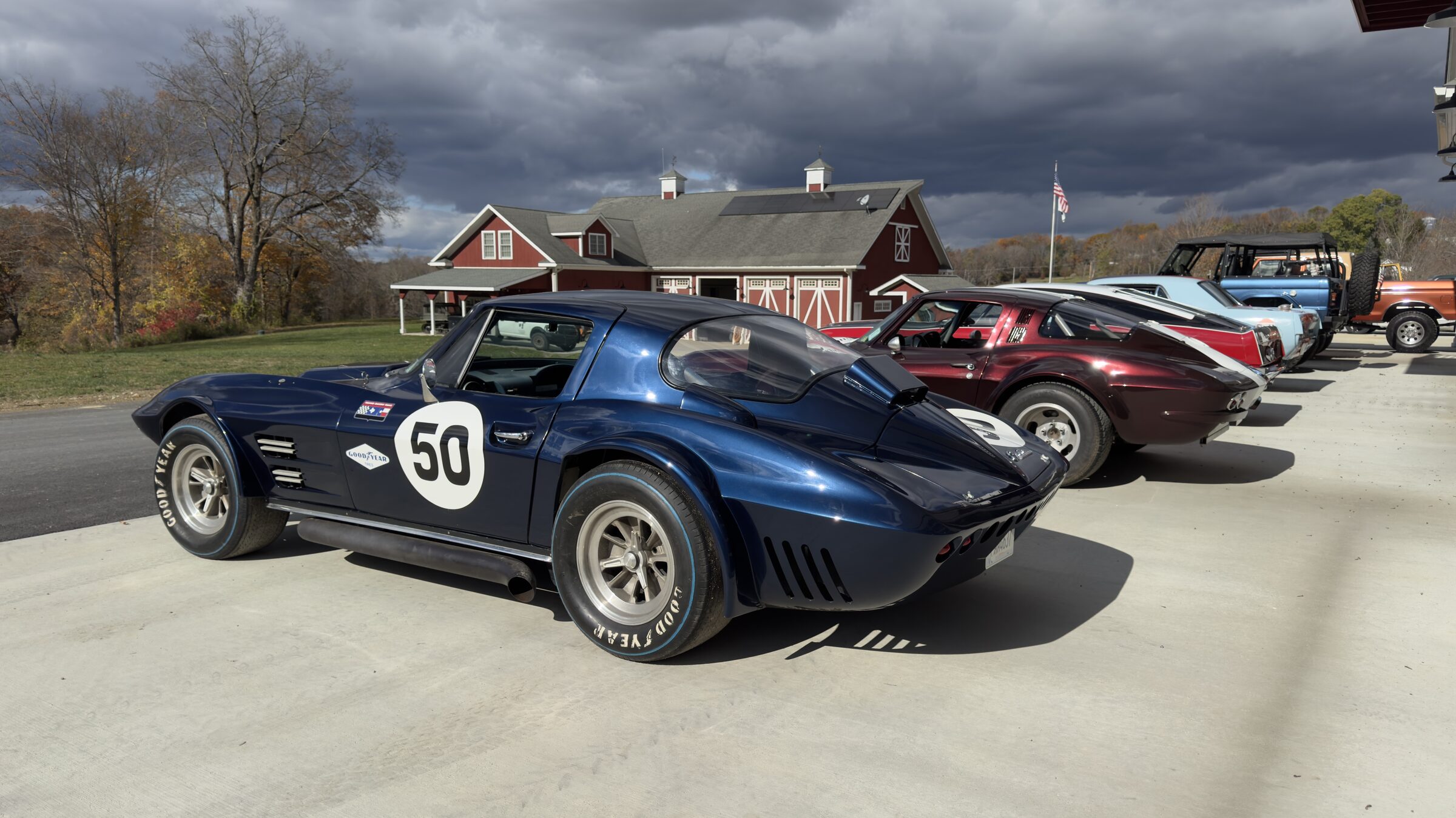Vintage cars and trucks gathered outside the Talus Motorsports garage